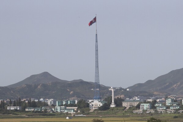 FILE - A North Korean flag flutters in the wind atop a 160-meter (525-foot) tower in the North's Kijong-dong village near the truce village of Panmunjom in the Demilitarized Zone in Paju, South Korea on Sept, 28, 2017. South Korea's spy agency said Tuesday, July 16, 2024, that a North Korea diplomat based in Cuba has defected to South Korea.(AP Photo/Lee Jin-man, File)