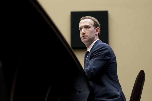 In this April 11, 2018, photo, Facebook CEO Mark Zuckerberg listens to a question as he testifies before a House Energy and Commerce hearing on Capitol Hill in Washington. Facebook is rebuffing efforts by U.S. Attorney General William Barr to give authorities a way to read encrypted messages. The heads of Facebook-owned WhatsApp and Messenger services told Barr and his U.K. and Australian counterparts that Facebook is moving forward with plans to enable end-to-end encryption on all of its messaging services. End-to-end encryption locks up messages so that not even Facebook can read their contents.  (AP Photo/Andrew Harnik, File)