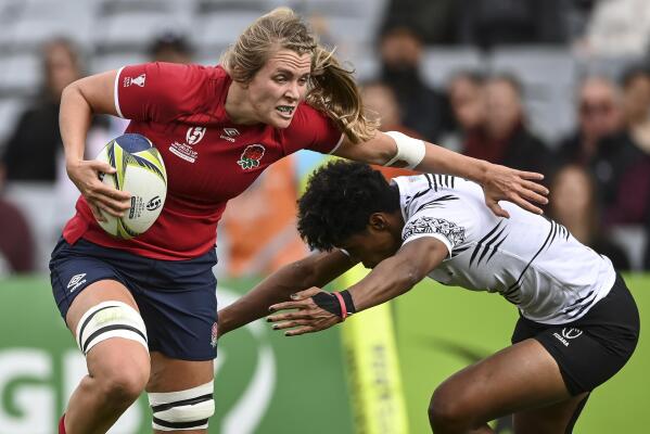Zoe Aldcroft of England is tackled by a defender during the Women's Rugby World Cup pool match between England and Fiji, at Eden Park, Auckland, New Zealand, Saturday, Oct.8. 2022. (Andrew Cornaga/Photosport via AP)
