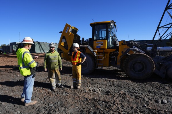 Workers talk at the Energy Fuels Inc. uranium Pinyon Plain Mine Wednesday, Jan. 31, 2024, near Tusayan, Ariz. (AP Photo/Ross D. Franklin)