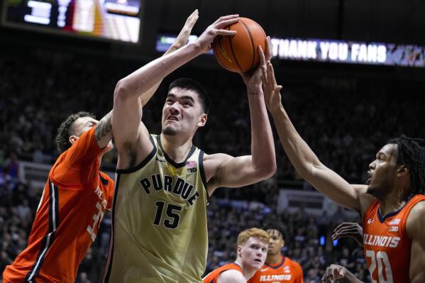 FILE -Purdue center Zach Edey (15) shoots between Illinois forward Coleman Hawkins (33) and forward Ty Rodgers (20) during the second half of an NCAA college basketball game in West Lafayette, Ind., Sunday, March 5, 2023. National player of the year Zach Edey of Purdue has declared for the NBA, but will keep open the option of returning to school next season. (AP Photo/Michael Conroy, File)