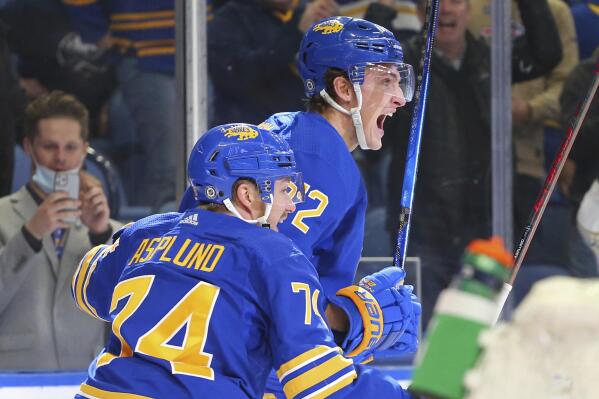 Buffalo Sabres forward Tage Thompson (72) celebrates his goal with forward Rasmus Asplund (74) during the third period of the team's NHL hockey game against the Vancouver Canucks, Tuesday, Oct. 19, 2021, in Buffalo, N.Y. (AP Photo/Jeffrey T. Barnes)
