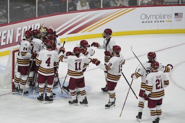 Boston College players celebrate a win against Michigan in a Frozen Four semifinal in the men's NCAA college hockey tournament Thursday, April 11, 2024, in St. Paul, Minn. (AP Photo/Abbie Parr)
