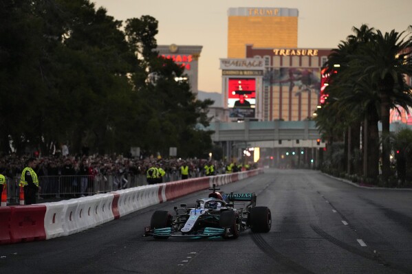 FILE - George Russell drives during a demonstration along the Las Vegas Strip at a launch party for the Formula One Las Vegas Grand Prix, Saturday, Nov. 5, 2022, in Las Vegas. There’s no such thing as a flawless first-year event, so go ahead and accept there will be bumps and bruises in Formula One’s $500 million Las Vegas Grand Prix. (AP Photo/John Locher, File)