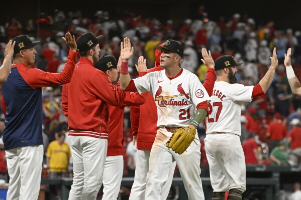 St. Louis Cardinals right fielder Lars Nootbaar (21), center, and teammates celebrate after their victory in a baseball game against the Boston Red Sox, Friday, May 17, 2024, in St. Louis. (AP Photo/Joe Puetz)