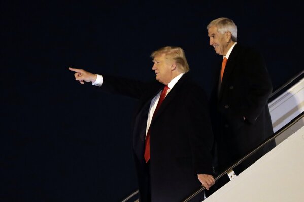 President Donald Trump arrives at Barksdale Air Force Base for a campaign rally in Bossier City, La., Thursday, Nov. 14, 2019, in Barksdale Air Force Base, La., with Louisiana Republican gubernatorial candidate Eddie Rispone. (AP Photo/ Evan Vucci)