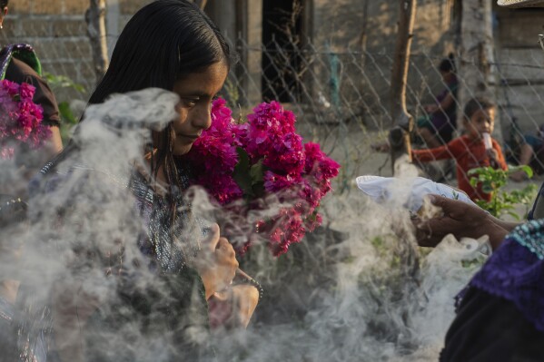 Francisca Perez attends a blessing ceremony for Communion wafers that will then be taken to a priest to be consecrated before they can be given out at the next day's service, in the Simojovel municipality, Mexico, Saturday, April 26, 2025. (AP Photo/Isabel Mateos)