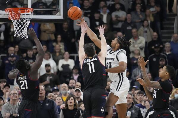 Providence forward Bryce Hopkins (23) drives to the basket against the Connecticut during the first half of an NCAA college basketball game, Wednesday, Jan. 4, 2023, in Providence, R.I. (AP Photo/Charles Krupa)