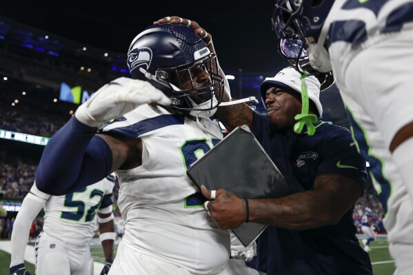 Seattle Seahawks defensive end Mario Edwards Jr., center, celebrates with teammates after forcing New York Giants quarterback Daniel Jones to fumble during the first quarter of an NFL football game, Monday, Oct. 2, 2023, in East Rutherford, N.J. (AP Photo/Adam Hunger)