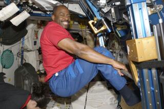 In this Nov. 22, 2009 photo made available by NASA, astronaut Leland Melvin, STS-129 mission specialist, exercises in the Unity module of the International Space Station while the space shuttle Atlantis is docked with the station. Space station astronauts exercise two hours every day to counter the muscle- and bone-withering effects of weightlessness, quickly leaving their workout clothes sweaty, smelly and stiff. Their T-shirts, shorts and socks end up so foul that they run through a pair every week, according to Melvin, a former NASA astronaut and NFL player. (NASA via AP)