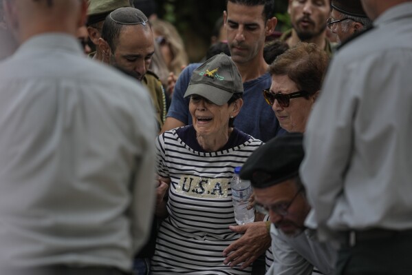 FILE - The mother of Israeli Col. Roi Levy cries during her son's funeral at the Mount Herzl cemetery in Jerusalem on Monday, Oct. 9, 2023. Col. Levy was killed after Hamas militants stormed from the blockaded Gaza Strip into nearby Israeli towns. (AP Photo/Maya Alleruzzo, File)