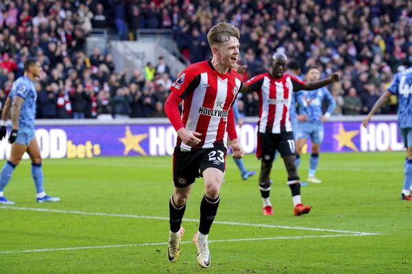 Brentford's Keane Lewis-Potter celebrates scoring his side's first goal of the game, during the English Premier League soccer match between Brentford and Aston Villa at the Gtech Community Stadium, in London, Sunday, Dec. 17, 2023. (Jonathan Brady/PA via AP)