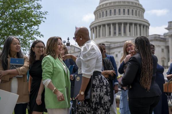 Activist Alyssa Milano, left, is greeted by Rep. Ayanna Pressley, D-Mass., center, as they arrive to tell reporters they want to remove the deadline for ratification of the Equal Rights Amendment, during a news conference at the Capitol in Washington, Thursday, April 27, 2023. Senate Republicans on Thursday blocked a Democratic measure to revive the Equal Rights Amendment. (AP Photo/J. Scott Applewhite)
