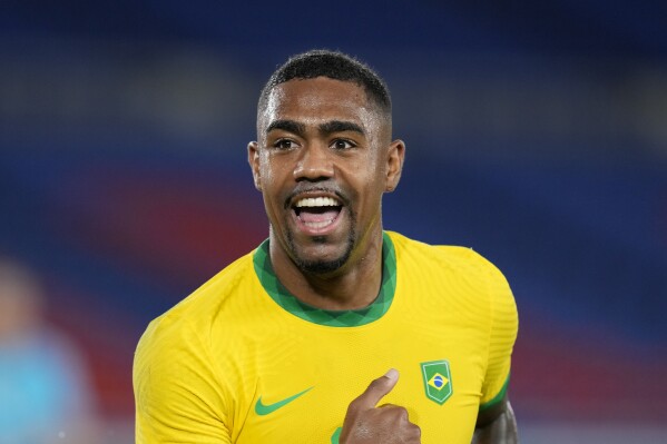 FILE - Brazil's Malcom celebrates scoring his side's second goal against Spain in the men's soccer final match at the 2020 Summer Olympics, Saturday, Aug. 7, 2021, in Yokohama, Japan. Three days after defeating Al-Nassr in the semifinal, during which Ronaldo was sent off for elbowing Ali Al-Bulaihi, two goals from Brazilian winger Malcom did the damage for Al-Hilal. Salem Al-Dawsari and Nasser Al-Dawsari sealed the win with late goals.(AP Photo/Fernando Vergara, File)