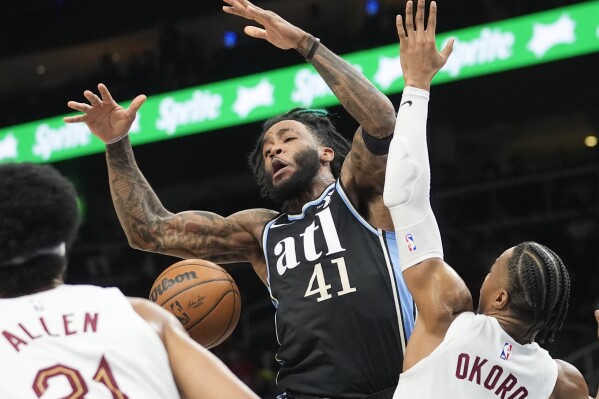 CORRECTS TO SADDIQ BEY, INSTEAD OF BRUNO FERNANDO - Atlanta Hawks forward Saddiq Bey (41) loses control of the ball as he drives against Cleveland Cavaliers forward Isaac Okoro (35) during the first half of an NBA basketball game Wednesday, March 6, 2024, in Atlanta. (AP Photo/John Bazemore)