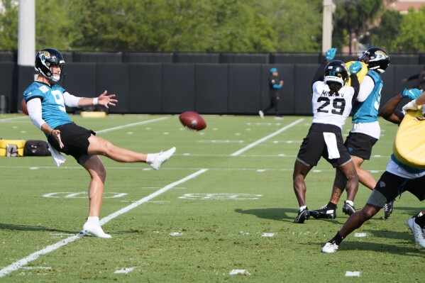 Jacksonville Jaguars punter Logan Cooke (9) punts during a team NFL football practice, Monday, June 2, 2025, in Jacksonville, Fla. (AP Photo/John Raoux)