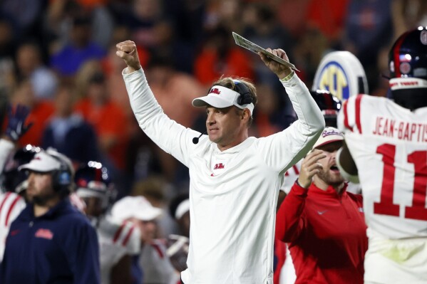 Mississippi head coach Lane Kiffin, center, reacts after an interception against Auburn during the second half of an NCAA college football game, Saturday, Oct. 21, 2023, in Auburn, Ala. (AP Photo/Butch Dill )