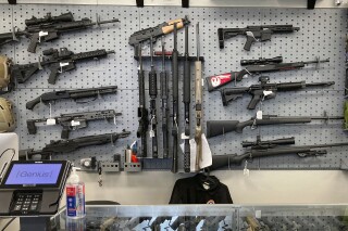 FILE - Firearms are displayed at a gun shop in Salem, Ore., Feb. 19, 2021. On Monday, Jan. 8, 2024, an Oregon judge entered the final order striking down a gun control law that was narrowly approved by voters in 2022. (AP Photo/Andrew Selsky, File)