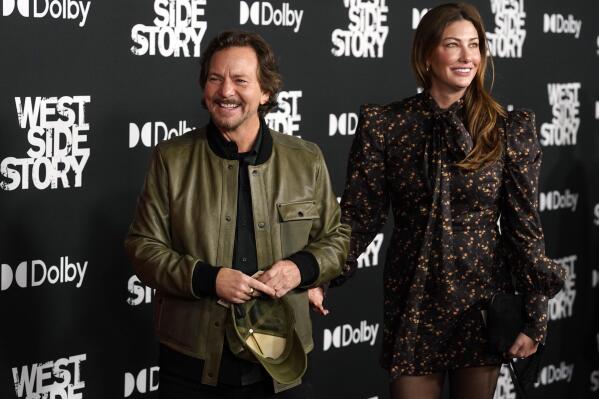 Pearl Jam singer Eddie Vedder and his wife Jill McCormick arrive at the premiere of the film "West Side Story," Tuesday, Dec. 7, 2021, at the El Capitan Theatre in Los Angeles. (AP Photo/Chris Pizzello)