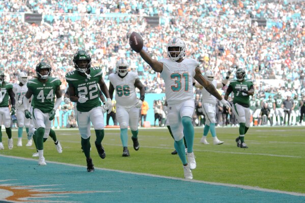 Miami Dolphins running back Raheem Mostert (31) scores a touchdown during the first half of an NFL football game against the New York Jets, Sunday, Dec. 17, 2023, in Miami Gardens, Fla. (AP Photo/Rebecca Blackwell)