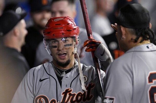 Detroit Tigers' Javier Baez wears a Red Wings hockey helmet in the dugout after his solo home run against the Los Angeles Angels during the fourth inning of a baseball game in Anaheim, Calif., Friday, Sept. 15, 2023. (AP Photo/Alex Gallardo)