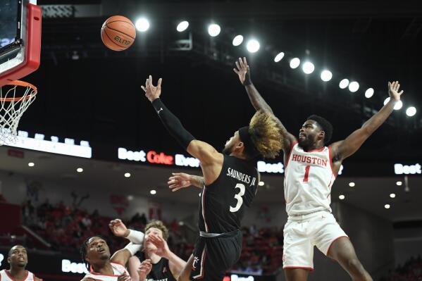 Cincinnati guard Mike Saunders Jr. (3) shoots next to Houston guard Jamal Shead (1) during the first half of an NCAA college basketball game Tuesday, March 1, 2022, in Houston. (AP Photo/Justin Rex)