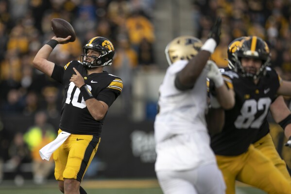 Iowa Hawkeyes quarterback Deacon Hill (10) makes a touchdown pass to Iowa Hawkeyes tight end Erick All (83) during Iowa's home football game against Purdue on Saturday, Oct. 7, 2023, Kinnick Stadium in Iowa City, Iowa. (Geoff Stellfox/The Gazette via AP)