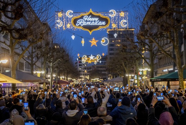 A "Happy Ramadan" sign is illuminated on the occasion of the beginning of the holy month of Ramadan, when observant Muslims fast from dawn to dusk, in a pedestrian zone in Frankfurt, Germany, Sunday, March 10, 2024. (AP Photo/Michael Probst)