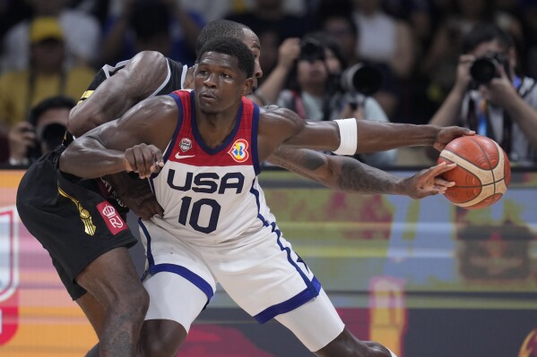 Jordan forward Rondae Hollis Jefferson (24) goes over the top of U.S. guard Anthony Edwards (10) during the first half of a Basketball World Cup group C match in Manila, Philippines Wednesday, Aug. 30, 2023. (AP Photo/Michael Conroy)