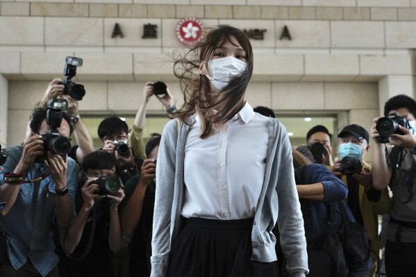 FILE - Hong Kong activist Agnes Chow arrives at a court in Hong Kong, Monday, Nov. 23, 2020. One of Hong Kong’s best-known pro-democracy activists, who moved to Canada to pursue further studies, said she would not return to the city to meet her bail conditions, becoming the latest politician to flee Hong Kong under Beijing's crackdown on dissidents. (APPhoto/Vincent Yu, File)