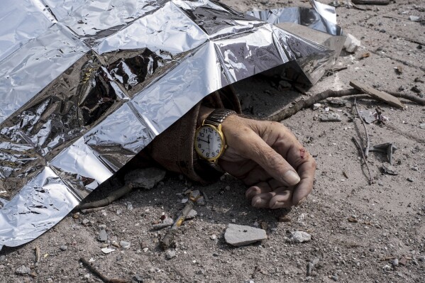 A dead body lies on the ground after a Russian missile strike on Sumy, Ukraine, Sunday April 13, 2025. (AP Photo/Volodymyr Hordiienko)
