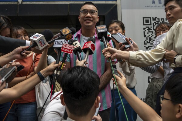Activist Henry Tse, who won an appeal to change the gender on his ID card, speaks to media members after receiving the new document in Hong Kong, Monday, April. 29, 2024. The Hong Kong transgender activist who fought a years-long legal battle to change the gender on his official identity card finally received the new document on Monday, vowing to continue working hard on the unfinished path of fighting for equality for his community. (AP Photo/Vernon Yuen)