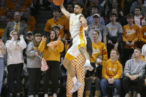 Tennessee forward Olivier Nkamhoua (13) saves the ball from going out of bounds during an NCAA college basketball game against Arizona Wednesday, Dec. 22, 2021, in Knoxville, Tenn. (AP Photo/Wade Payne)