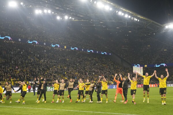Dortmund's players celebrate with fans after winning the Champions League quarterfinal second leg soccer match between Borussia Dortmund and Atletico Madrid at the Signal-Iduna Park in Dortmund, Germany, Tuesday, April 16, 2024. Dortmund stands in the semifinal against PSG. (AP Photo/Martin Meissner)