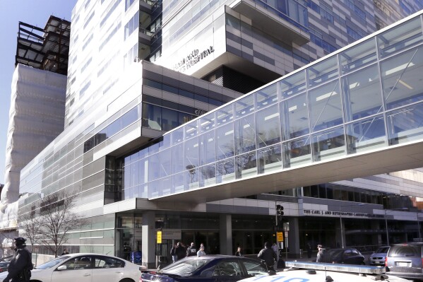 FILE - Pedestrians walk past the Shapiro Building at Brigham and Women's Hospital, Jan. 20, 2015, in Boston. Some women who spent months preparing for in vitro fertilization procedures have been left devastated after flooding from a burst water main at the hospital on Christmas Eve, Sunday, Dec. 24, 2023, disrupted services for about 200 IVF patients. (AP Photo/Steven Senne, File)