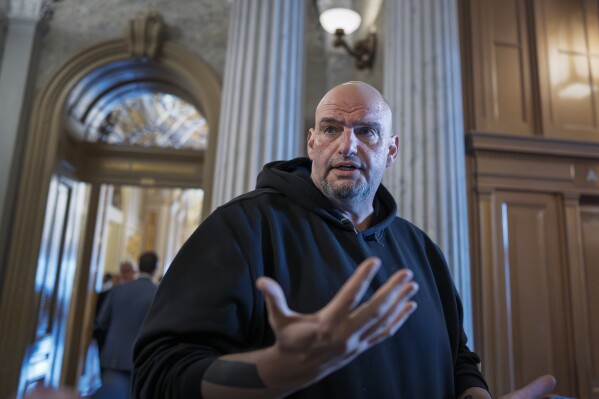 Sen. John Fetterman, D-Pa., talks to reporters outside the chamber during a vote at the Capitol in Washington, March 13, 2025. (AP Photo/J. Scott Applewhite, File)