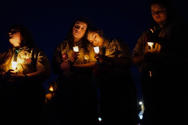 People gather at a vigil in Lisbon Falls, Maine, for the victims of the week's mass shootings, Saturday, Oct. 28, 2023. (AP Photo/Matt Rourke)