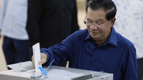 Cambodian Prime Minister Hun Sen of the Cambodian People's Party (CPP) drops a ballot into a box for voting at a polling station at Takhmua in Kandal province, southeast Phnom Penh, Cambodia, Sunday, July 23, 2023. Cambodians go to the polls Sunday with incumbent Prime Minister Hun Sen and his party all but assured a landslide victory thanks to the effective suppression and intimidation of any real opposition that critics say has made a farce of democracy in the Southeast Asian nation. (AP Photo/Heng Sinith)