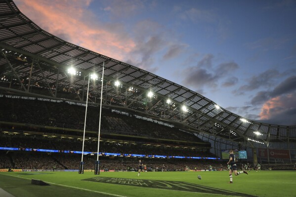 Scotland's Finn Russell, right, runs to gather a loose ball during the Six Nations international rugby union match between Ireland and Scotland, at the Aviva stadium in Dublin, Ireland, Saturday, March 16, 2024. (AP Photo/Peter Morrison)