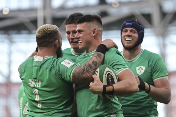 Ireland's Dan Sheehan, centre, celebrates with team mates after scoring a try during a Six Nations rugby union match between Ireland and Italy at the Aviva Stadium in Dublin, Sunday Feb.11, 2024. (AP Photo/Peter Morrison)