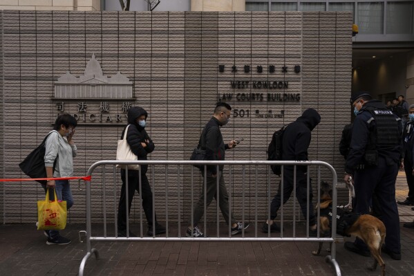 Members of the public line up to enter the West Kowloon Magistrates' Courts, where activist publisher Jimmy Lai's trial takes place, in Hong Kong, Tuesday, Dec. 19, 2023. The national security trial of Hong Kong's most famous activist publisher Jimmy Lai entered its second day, with judges expected to rule on his lawyer's bid to throw out a sedition charge that has been increasingly used to target dissidents under Beijing's crackdown on Friday. (AP Photo/Louise Delmotte)