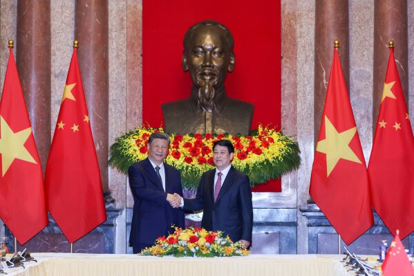 Vietnam's President Luong Cuong, right, and Chinese President Xi Jinping shake hands at the Presidential Palace in Hanoi, Vietnam, Tuesday, April 15, 2025. (AP Photo/Minh Hoang, Pool