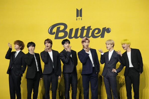 FILE - Members of South Korean K-pop band BTS, V, SUGA, JIN, Jung Kook, RM, Jimin, and j-hope from left to right, pose for photographers ahead of a news conference to introduce their new single "Butter" in Seoul, South Korea, May 21, 2021. Four more members of the K-pop supergroup BTS are to begin their mandatory South Korean military duties soon, their management agency said. (AP Photo/Lee Jin-man, File)