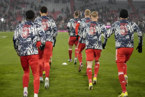 Bayern players warm-up all wearing the number 5 on their backs before the German Bundesliga soccer match between FC Bayern Munich and TSG 1899 Hoffenheim at the Allianz Arena in Munich, Germany, Friday, Jan. 12, 2024. This gesture was in honour of Franz Beckenbauer, a club legend for Bayern as a player, coach and president, whose death at the age of 78 has prompted tributes from across the soccer world but has left a particularly deep impression on Bayern the team where he spent so much of his decades-long career. (AP Photo/Matthias Schrader)
