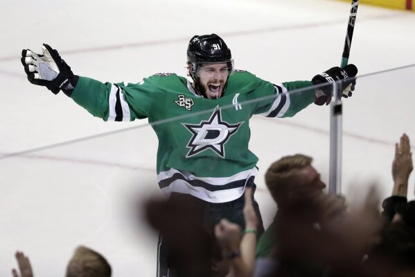 
              FILE - In this March 3, 2018, file photo, Dallas Stars' Tyler Seguin (91) celebrates their 3-2 overtime win in an NHL hockey game against the St. Louis Blues in Dallas. Seguin has signed a $78.8 million, eight-year contract extension with the Stars, general manager Jim Nill announced  Thursday, Sept. 13, 2018. (AP Photo/Tony Gutierrez, File)
            