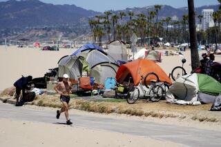 FILE - A jogger runs past a homeless encampment in the Venice Beach section of Los Angeles on June 8, 2021. The city and county of Los Angeles are seeking dismissal of a sweeping lawsuit about homelessness that demands local government find shelter for thousands of people living on the streets. Attorneys for the city and county have filed dismissal motions in federal court. (AP Photo/Marcio Jose Sanchez, File)
