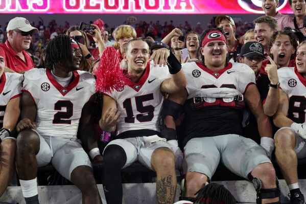 Georgia quarterback Carson Beck (15) celebrates with teammates and fans after defeating Florida in an NCAA college football game, Saturday, Oct. 28, 2023, in Jacksonville, Fla. (AP Photo/John Raoux)