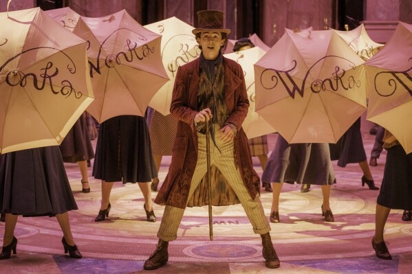 This image released by Warner Bros. Pictures shows Timothee Chalamet, center, in a scene from "Wonka." (Jaap Buittendijk/Warner Bros. Pictures via AP)