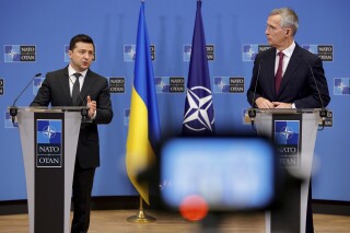 FILE - NATO Secretary General Jens Stoltenberg, right, and Ukraine's President Volodymyr Zelenskyy participate in a media conference at NATO headquarters in Brussels, Thursday, Dec. 16, 2021. Russia's war on Ukraine will top the agenda when U.S. President Joe Biden and his NATO counterparts meet in the Lithuanian capital Vilnius on Tuesday and Wednesday. (AP Photo/Olivier Matthys, File)