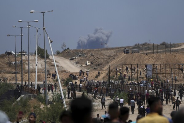 Smoke rises following an Israeli bombardment in southern Gaza, as seen from a humanitarian aid distribution center operated by the U.S.-backed Gaza Humanitarian Foundation, approved by Israel, in Khan Younis, southern Gaza Strip, on Thursday, May 29, 2025. (AP Photo/Abdel Kareem Hana)